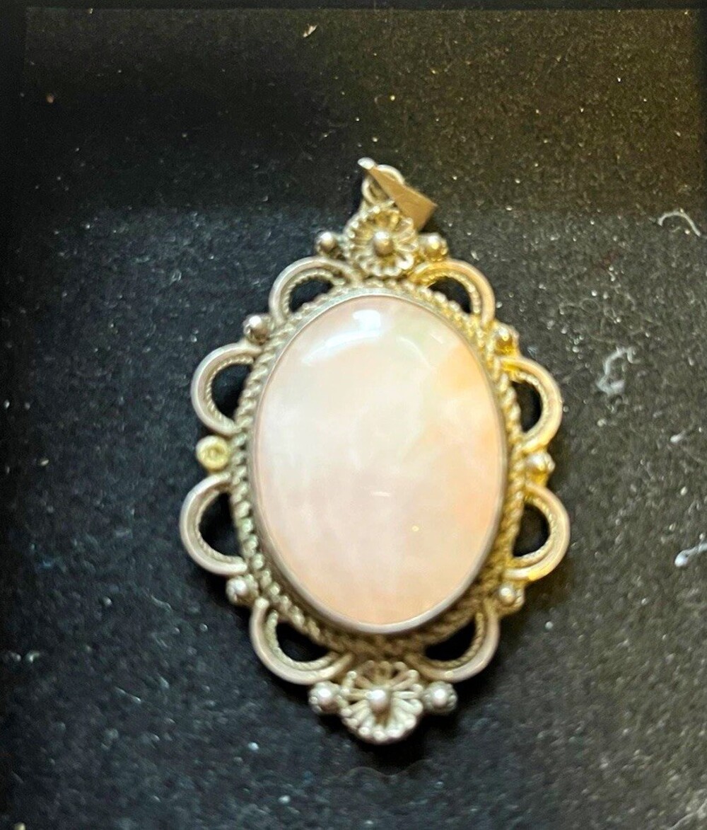 Antique sterling silver with pink quarts pendant.